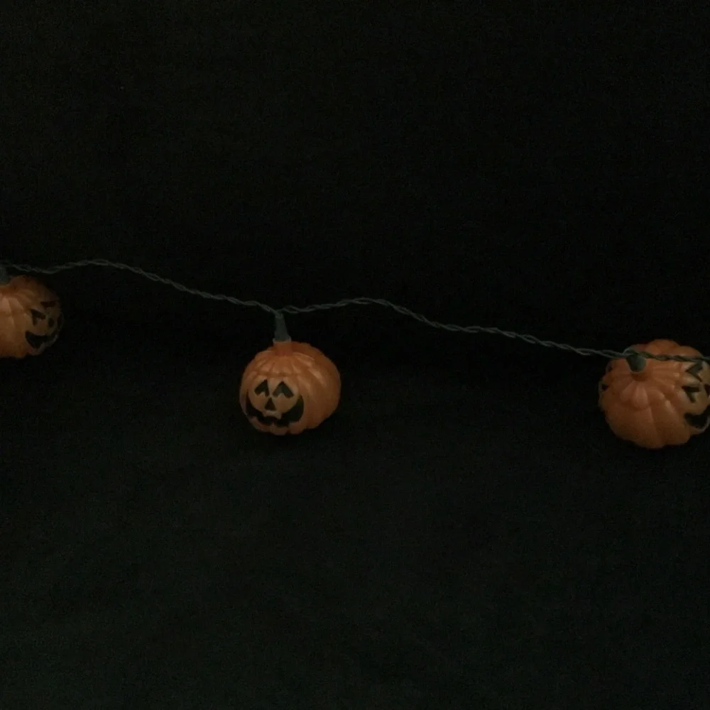Halloween stein lights. Plastic 9’ long . 10 pumpkin lights on string.